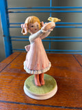 Vintage Ceramic Figurine of Girl Holding a Yellow Bird