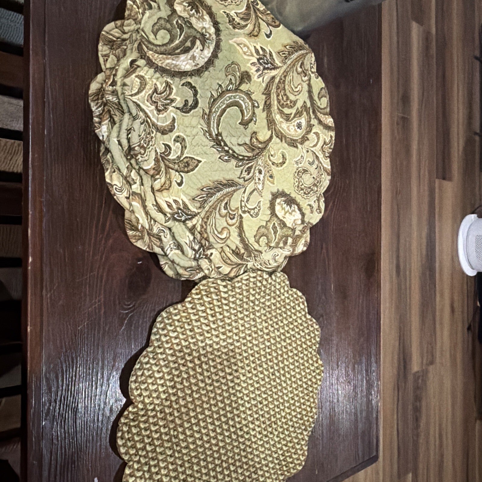 quilted placemats feature a sage green and brown paisley with a scalloped edge.